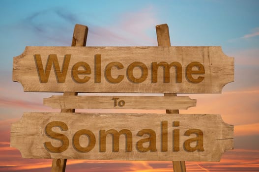 welcome to jamaica sign on wood background with blending national flag