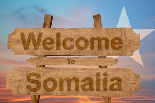 welcome to jamaica sign on wood background with blending national flag
