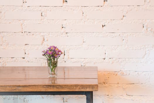 Room interior white brick wall with wooden table, stock photo