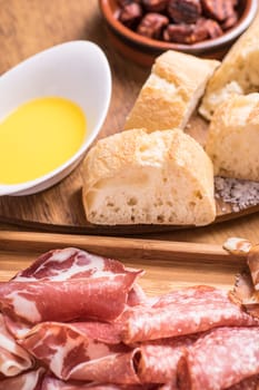 Tapas food, served in small bowls cold meat, goat cheese. A meal for sharing