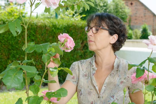 a middle aged woman with glasses in the garden