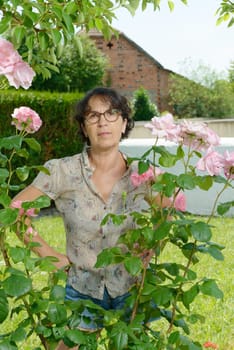 a middle aged woman with glasses in the garden