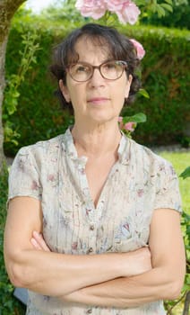 a middle aged woman with glasses in the garden