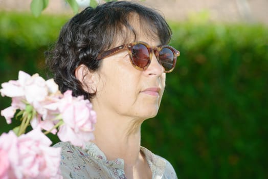 mature  woman with sunglasses in the garden