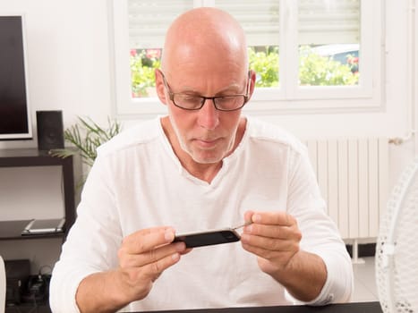 mature man repaired a smartphone