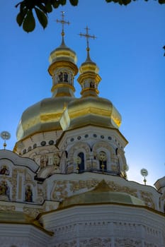 Golden tops and crosses of Christian Orthodox Abbey. Vertical photo