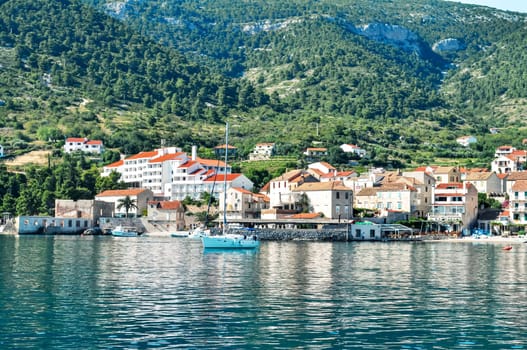 Small town bay with sail yachts
