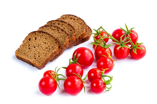 Composition of black bread and bunch of cherry tomatoes