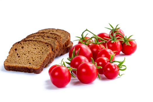 Composition of black bread and bunch of cherry tomatoes