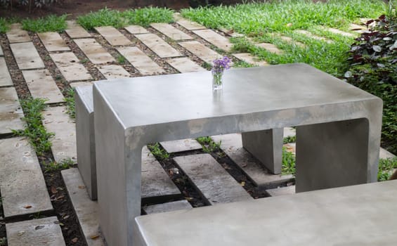 Concrete outdoor furniture set in the small garden, stock photo