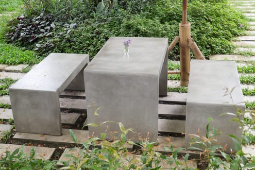 Concrete outdoor furniture set in the small garden, stock photo