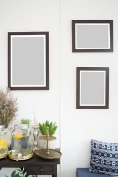 Room interior with frames on white wall, stock photo
