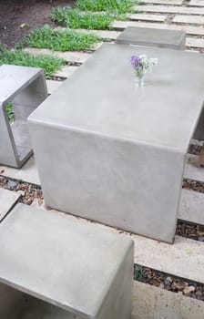 Concrete outdoor furniture set in the small garden, stock photo