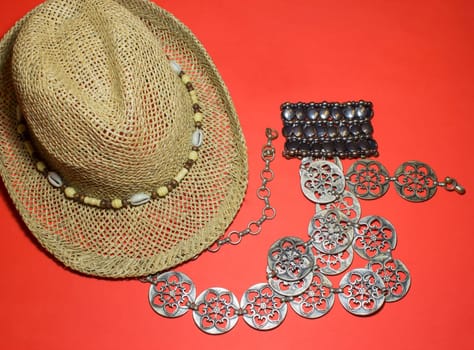 The stylish summer beach accessories. Vacation mood. Straw hat, belt and a bracelet.