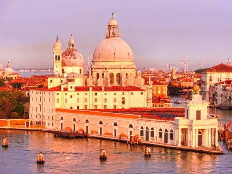 Beautiful view from Grand Canal on colorful facades of old medieval houses in Venice, Italy at sunset