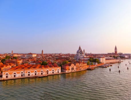 Beautiful view from Grand Canal on colorful facades of old medieval houses in Venice, Italy at sunset