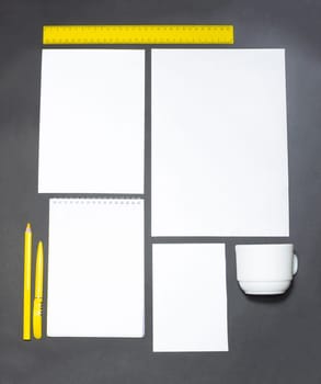 Mock-up business template with cards, papers, pen on gray background.