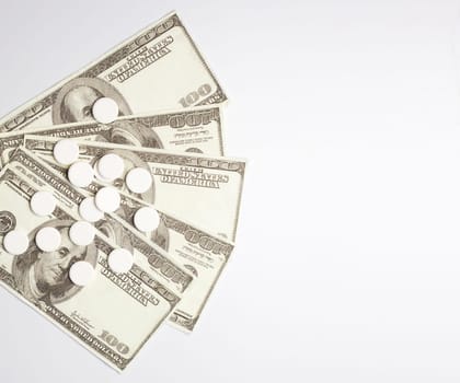 White pills and money, health expense concept, health care cost, medical business