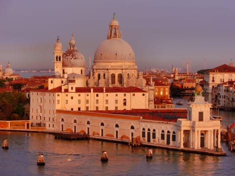 Beautiful view from Grand Canal on colorful facades of old medieval houses in Venice, Italy at sunset