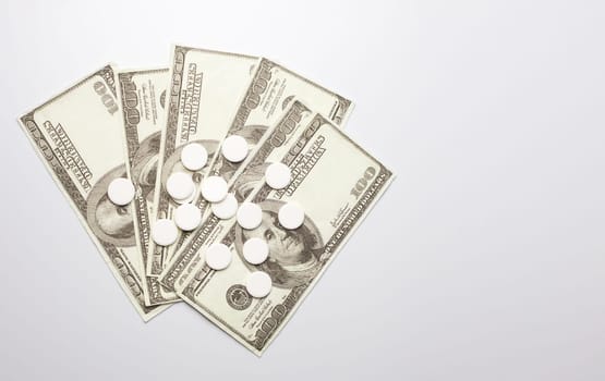 White pills and money, health expense concept, health care cost, medical business