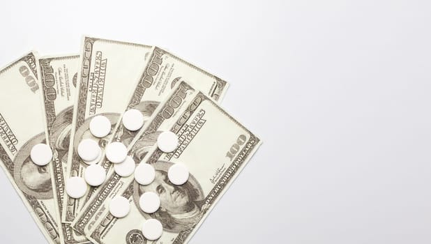 White pills and money, health expense concept, health care cost, medical business