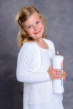 smiling nice girl on day of her first communion