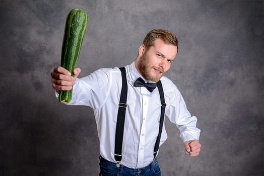young angry vegetarian minatory with zucchini cudgel