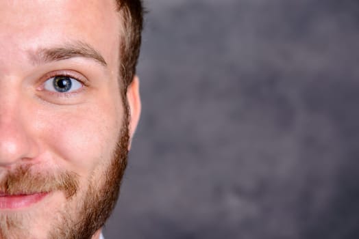 close up - portrait of a young friendly, bearded man