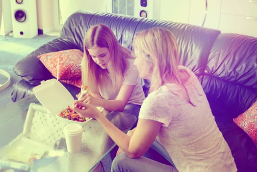 mother and daughter eating together fast food