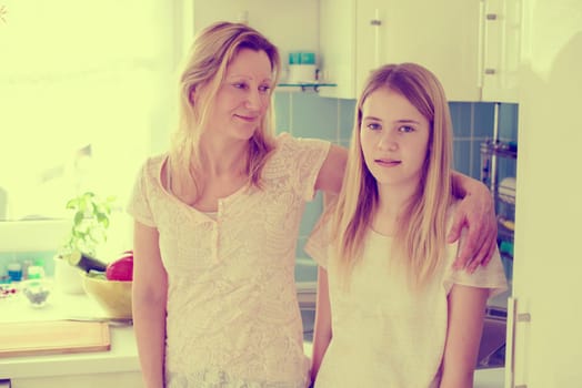 blond mother hugged her daughter at home