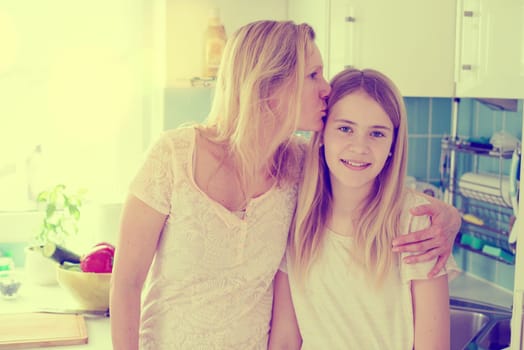 blond mother hugged her daughter at home