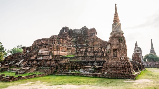 Ancient ruins of pagoda under sun light at Wat Phra Mahathat temple is a famous attractions in Phra Nakhon Si Ayutthaya Historical Park, Thailand