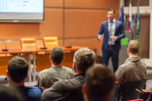 Speaker giving a talk in conference hall at business event. Audience at the conference hall. Business and Entrepreneurship concept.