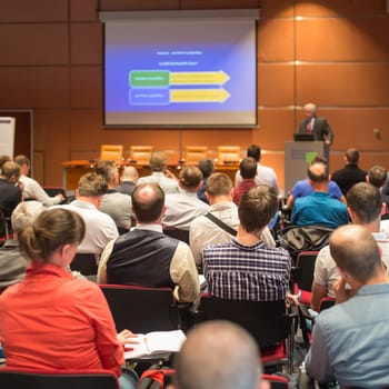 Speaker Giving a Talk at Business Meeting. Audience in the conference hall. Business and Entrepreneurship.