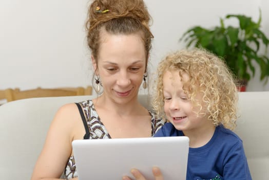 a blond little boy and his mom with a digital tablet