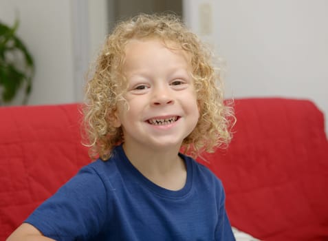 a portrait of a little boy with blond curly hair