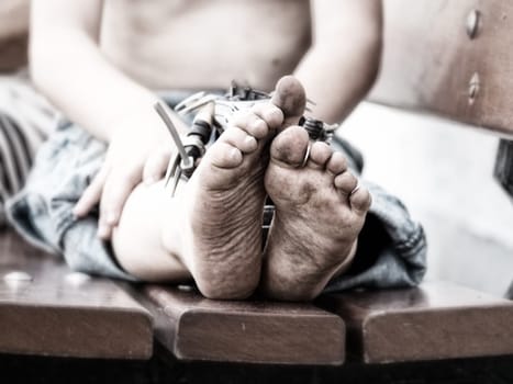 a closeup of dirty feet of a little boy