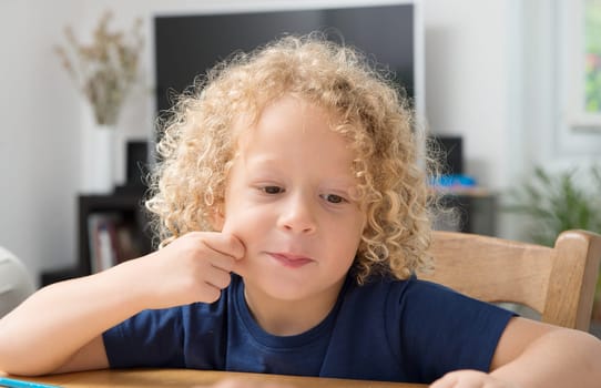 a portrait of a little boy with blond curly hair