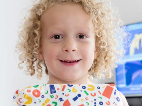 smiling little blond boy with a gift