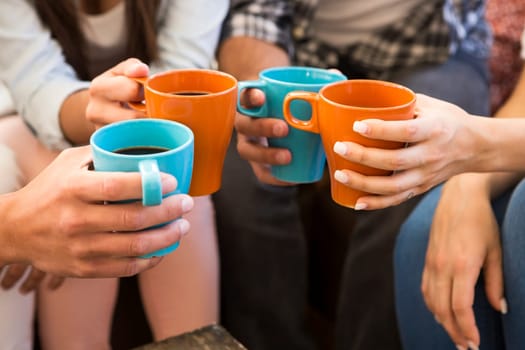Group of friends making a toast with coffee