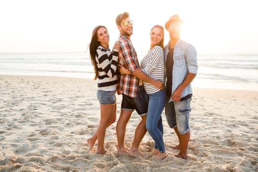Group of friends at the beach and looking back