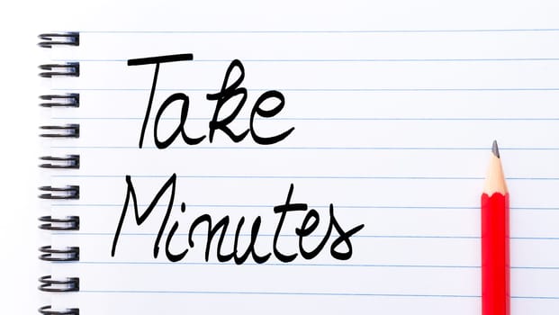 Take Minutes written on notebook page with red pencil on the right