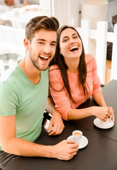 Youg couple at the local coffee shop drinking a coffee