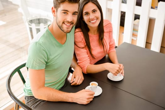 Youg couple at the local coffee shop drinking a coffee