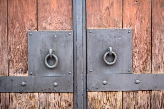 Wooden door with metal handlers
