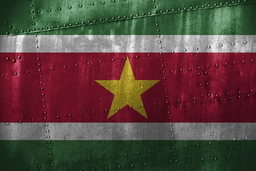 metal texutre or background with suriname flag
