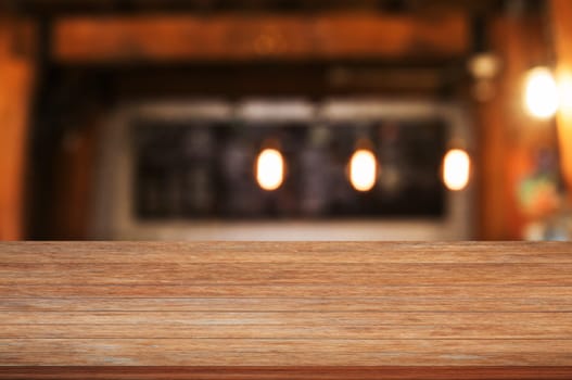 Top of wooden table top with coffee shop blurred abstract background