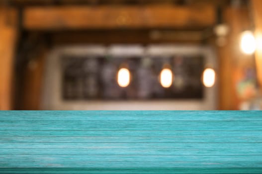 Top of blue wooden table with coffee shop blurred abstract background