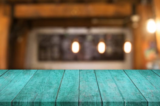 Blue wooden table top with coffee shop blurred abstract background