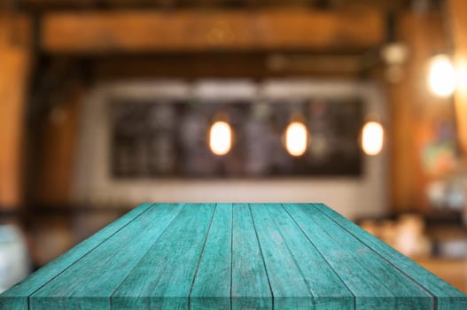 Perspective blue wooden table top with coffee shop blurred abstract background